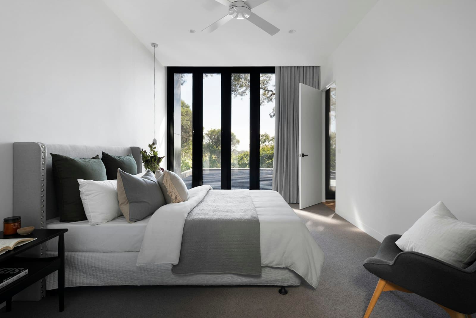 Light, simply furnished bedroom with large windows