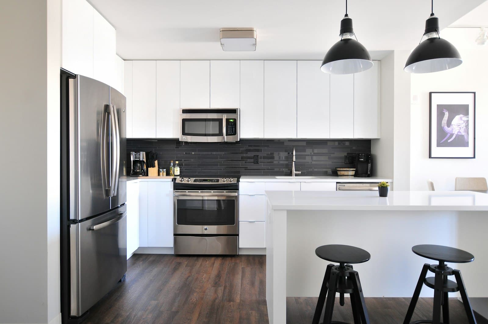 Clean, modern apartment kitchen with pendant lights